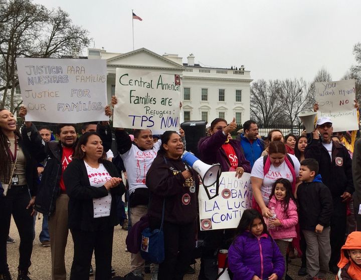 Protesters outside the White House Wednesday call for the Obama administration to offer temporary protected status to those fleeing violence in Central America.