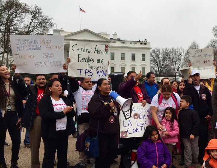 Protesters outside the White House Wednesday call for the Obama administration to offer temporary protected status to those fleeing violence in Central America.