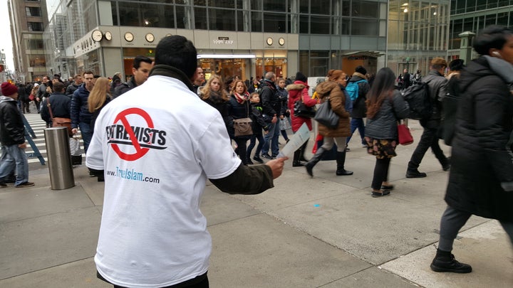 A member of Ahmadiyya Muslim Youth Association USA passes out anti-extremism flyers in New York City on December 31, 2015.