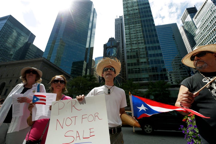 Protesters demonstrate at the Puerto Rican debt talks outside Citibank Inc. headquarters on Park Avenue in New York City, on July 13, 2015.