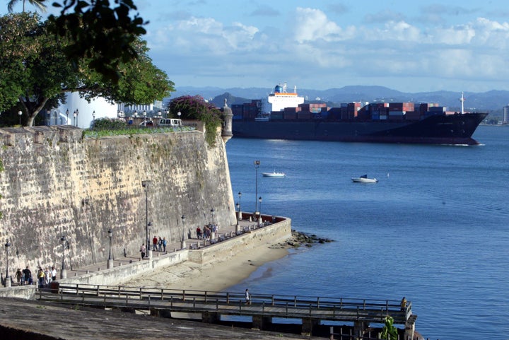 A ship passes past part of the wall that makes up La Fortaleza in Old San Juan, the original capital city of San Juan, Puerto Rico.