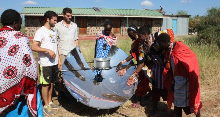 Maasai women test out cooking local cuisine on SolSource in Merrueshi, Kenya, with solar cooking trainers from the Masai Association.