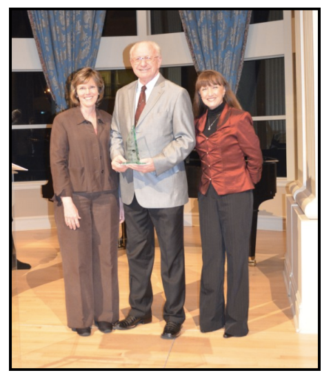 Kenneth Dewitt, in middle, holds his Employee of the Year award.