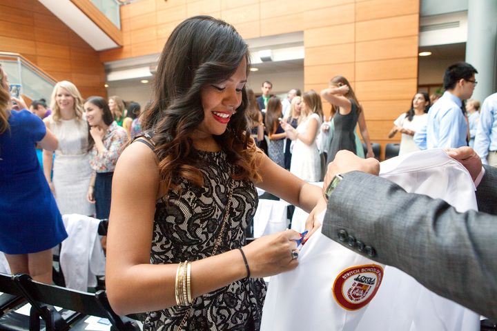 Emelin Garcia receives her white coat at a ceremony at Stritch School of Medicine at Loyola University Chicago.