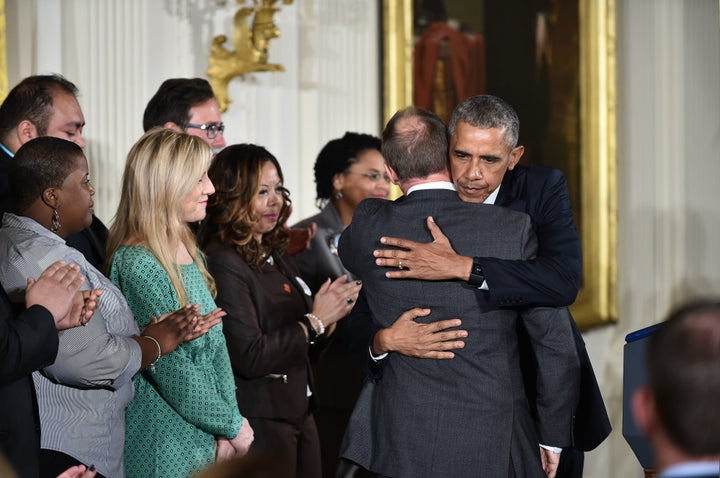 President Barack Obama embraces Mark Barden before his speech on gun violence.