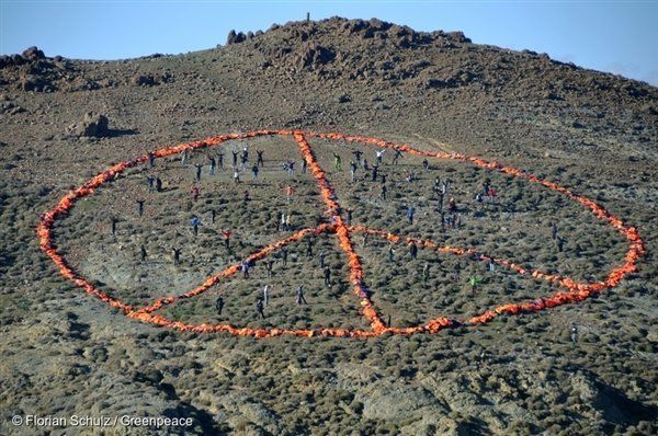 Aid workers stand inside a giant peace symbol created from life jackets on the Greek island of Lesbos.