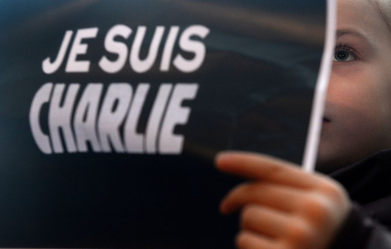 A girl holds up posters reading 'Je suis Charlie' (I am Charlie) in front of the French embassy on Jan. 10, 2015, in Prague.
