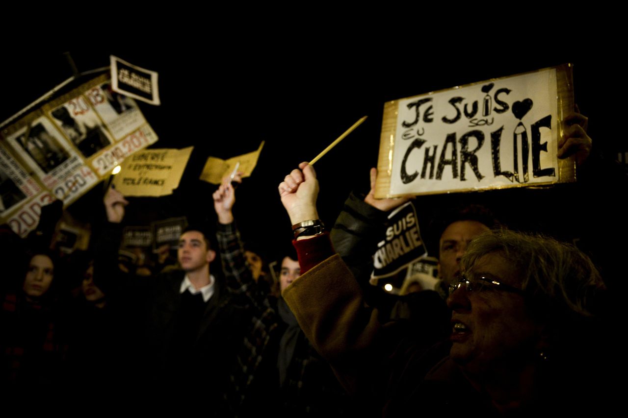 Hundreds of people gather holding pencils and posters reading 'Je Suis Charlie (I Am Charlie)' in Lisbon on Jan. 8, 2015.