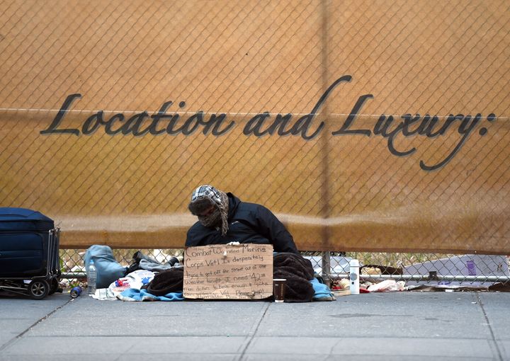 A homeless man looking for money for a room sits on 5th Avenue near 42nd Street in New York January 4, 2016 as he trys to stay warm in the cold temperatures. New York Governor Andrew Cuomo signed an executive order on January 3 that will make it mandatory to bring the homeless in out of the cold. The order, which goes into effect on January 5, calls for the involuntary taking of the homeless to shelters when the weather drops to 32 degrees or colder.