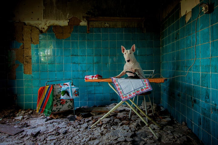 Claire ironing in an abandoned farmhouse in Netherlands.