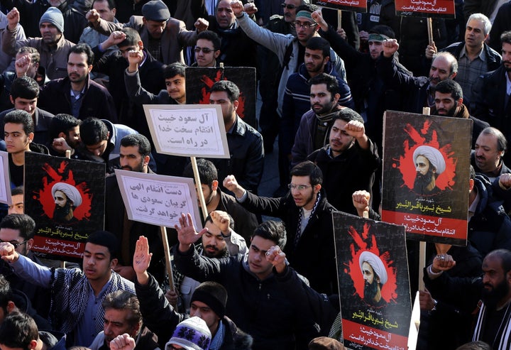 Demonstrators hold posters of Nimr Baqir al-Nimr during a rally in Tehran against his execution by Saudi authorities.