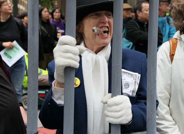 Protesters demonstrate outside a Wells Fargo Bank shareholders' meeting to make the point that no executives were jailed afte
