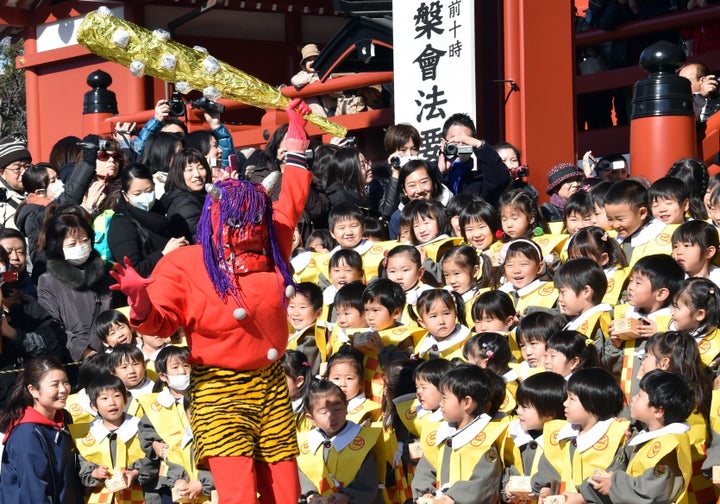 Children part in a traditional bean-throwing ceremony to drive away evil and bring good luck at the annual Setsubun Festival at Tokyo's Sensoji Temple.