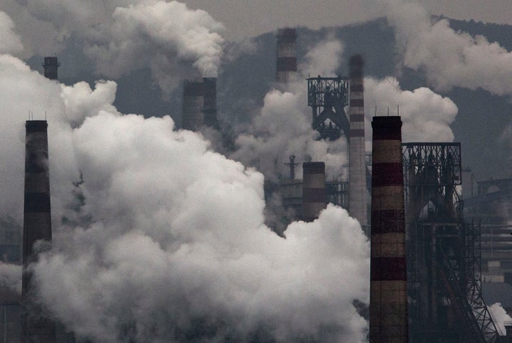 Smoke billows from smokestacks and a coal-fired generator at a steel factory on Nov. 19, 2015, in the industrial province of Hebei, China. Crackdowns on polluting steel or cement factories may have accounted for blue skies during the summer.