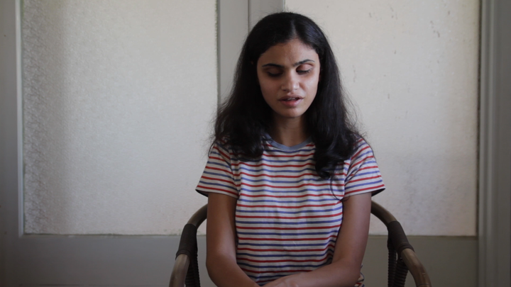 She uses a Braille display connected to a laptop to write stories. 