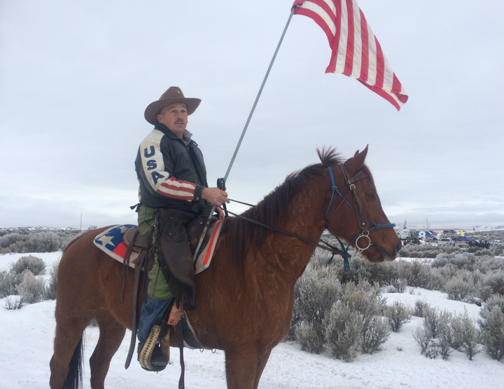 Hellboy and his owner, who was later identified as Duane Ehmer. The cowboy says he'll stay put at the occupation site until he runs out of food to feed his horse.