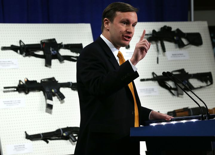Sen. Chris Murphy speaks next to a display of assault-style weapons during a news conference on Jan. 24, 2013, in Washington.