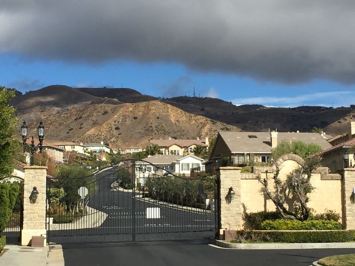 The gates of one of the many upscale residential communities in the Porter Ranch neighborhood. Residents have been evacuated, but many of them periodically return to their homes to do laundry, check on their property and keep their businesses operating.