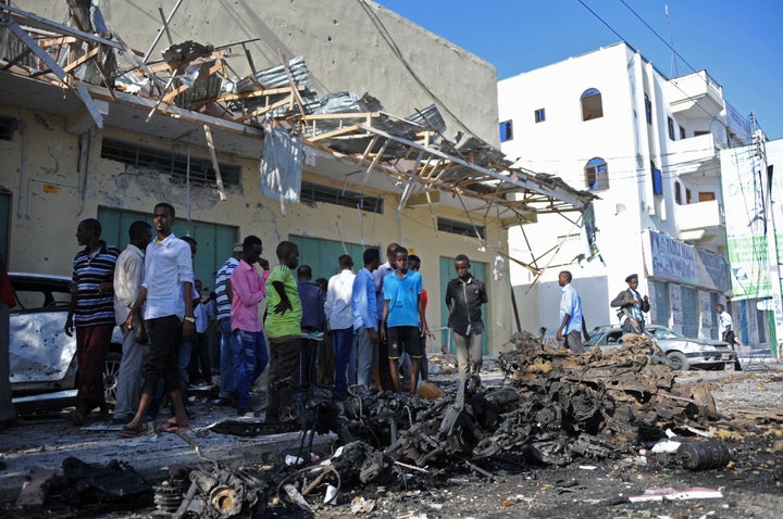 People gather near the site of a bomb blast in the Somali capital last December.