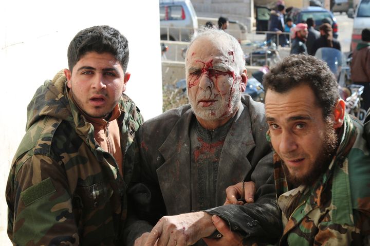 People bring a wounded person to hospital after the Russian airstrikes targeted a prison at opposition controlled Maret el Numan district of Idlib, Syria on January 9, 2016.
