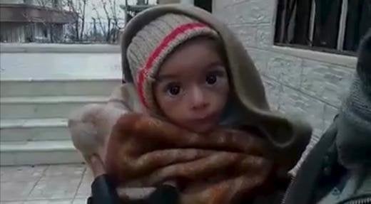 A toddler is held up to the camera in this still image taken from video said to be shot in Madaya on January 5, 2016.