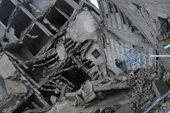 Blockades have been a common feature of the nearly five-year-old war that has killed 250,000 people. An activist sprays graff