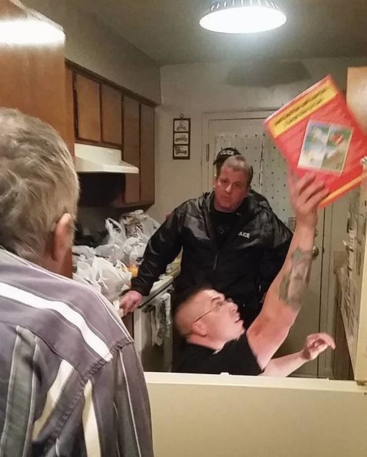 Officers with Tennessee's Mt. Pleasant Police Department are seen stocking an elderly man's kitchen.