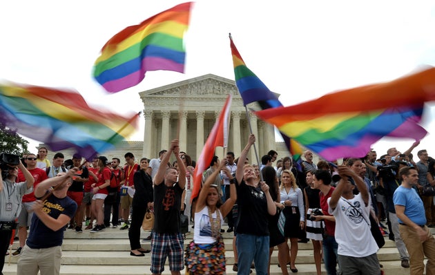 People celebrate outside the Supreme Court in Washington, DC in June, 2015, after its historic decision...
