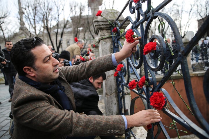 People leave flowers for victims of the attack at Istanbul's Sultanahmet square after it was reopened to the media and the public on Jan. 13, 2016. Many journalists ignored the media ban the Turkish government imposed after the bombing.