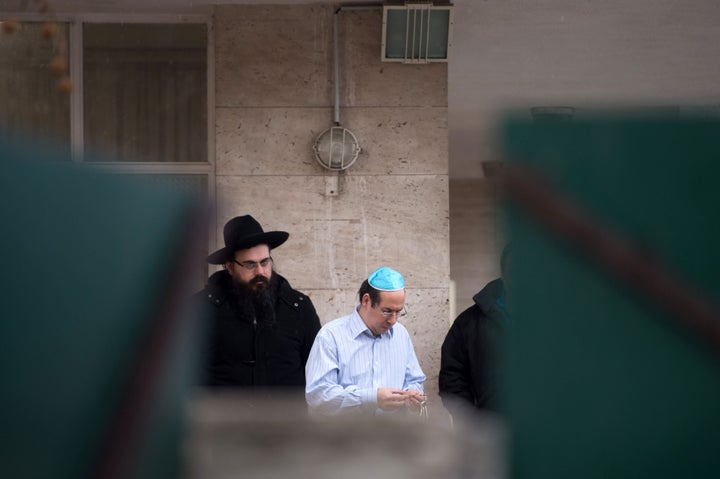 People stand in front of the La Source Jewish school in Marseille, France, on Jan. 11, 2016, after a Jewish teacher was attacked by a teenager wielding a machete.