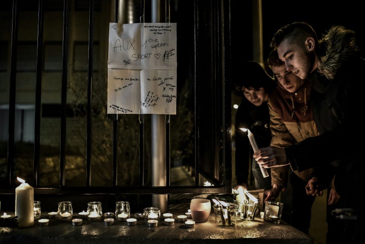 Two of the victims were teenagers. Students light candles outside the Saint-Exupery high school in Lyon, whose students and t