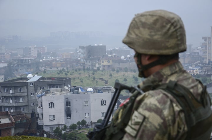 A soldier looks out over Cizre district after the government carried out an anti-terror campaign against the PKK there. Turkey's leaders have made clear that in their view, the PKK is as equal a threat as IS.