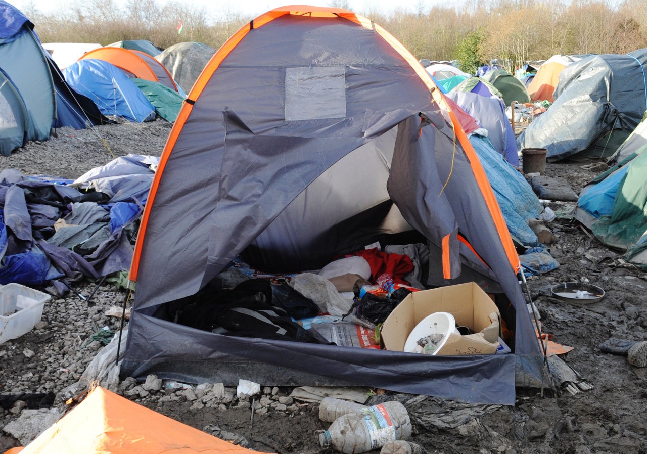 A refugee tent, filled with white bread, antiseptic, and blankets.