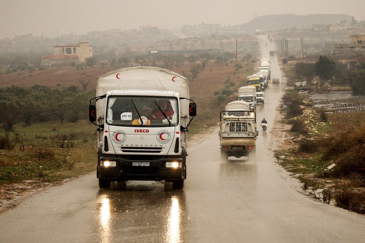 A Syrian Red Crescent convoy carrying humanitarian aid drives on a road in the town of Foua in Idlb, Syria, on Jan.