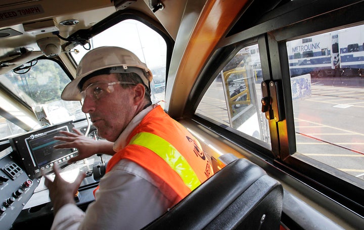 A mechanical systems manager with Metrolink explains the workings of PTC technology installed aboard a commuter tra
