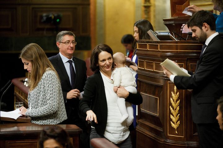Carolina Bescansa carries her son after casting her ballot during the inaugural meeting of Spain's parliament.
