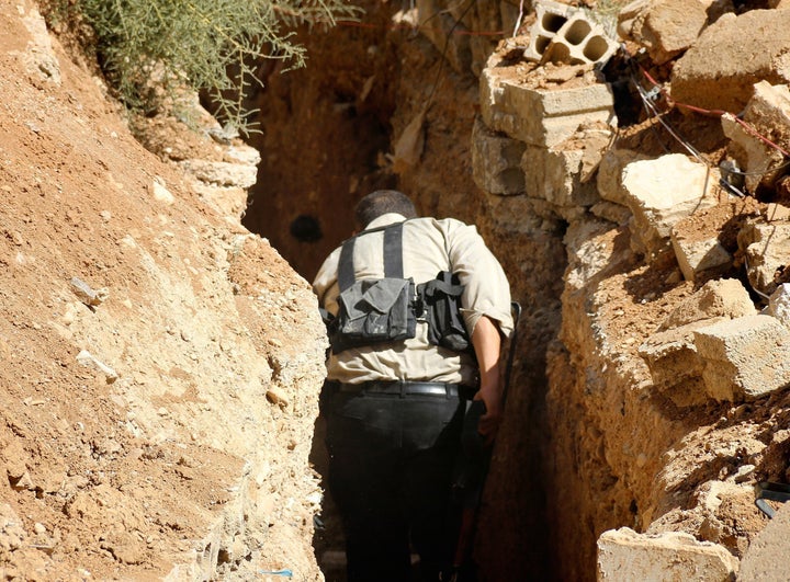 Residents living in areas under Syrian government siege have started to use rebel-held underground tunnels to escape or get provisions. In this photo, a regime opponent walks through a tunnel in Eastern Ghouta, Syria.