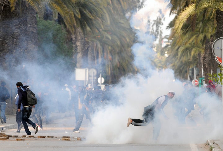 A Tunisian demonstrator throws a rock during clashes with security forces on Mohamed V Avenue in Tunis on Jan. 14, 2011.