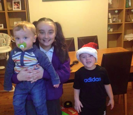 Archie posing with his big sister, Kellsie and big brother, Alfie.