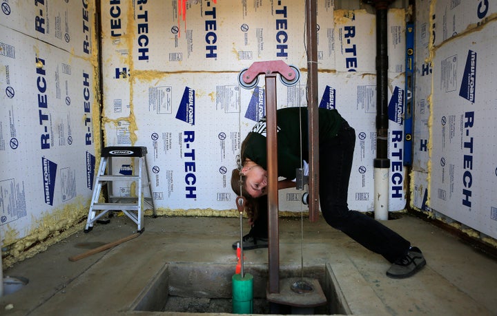 The subsidence has also required repairs and upgrades to the concrete lining of many canal walls. Hydrologist Michelle Snee checks monitoring data on the San Joaquin Valley's Delta Mendota Canal.