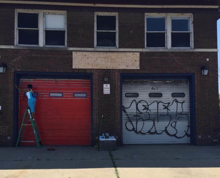 Erinn Currie, executive assistant for Liquid Flow, paints the former firehouse that will soon become a space for arts education.
