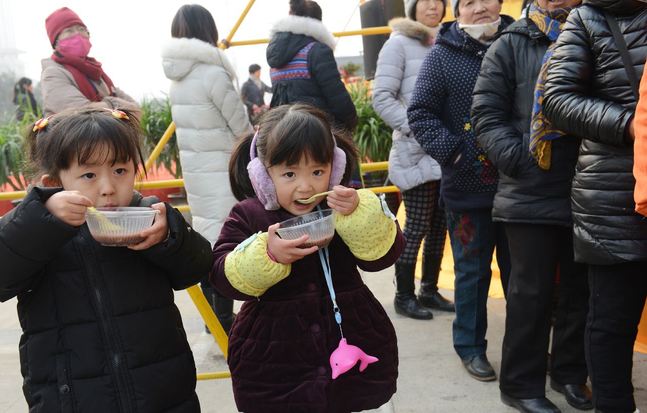 Thousands of people in China went to Buddhist temples to celebrate the Laba Festival, a holiday which entails eating bowls of congee, or rice porridge. Two girls eat Laba congee in Zhengzhou, Henan Province.