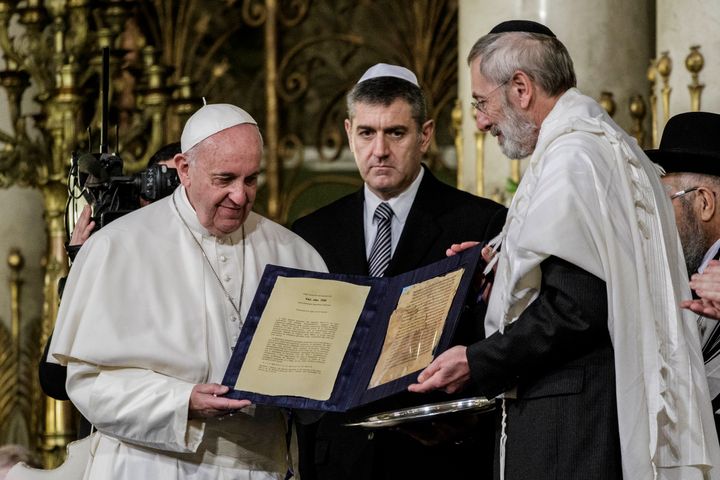 Pope Francis shows a gift donated from Rabbi Riccardo Di Segni (R) during his visit to the Great Synagogue of Rome, Italy. 