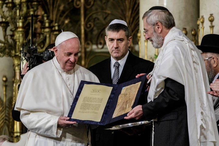 Pope Francis shows a gift donated from Rabbi Riccardo Di Segni (R) during his visit to the Great Synagogue of Rome, Italy.