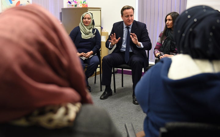 U.K. Prime Minister David Cameron speaks with women attending an English language class in Leeds, England. Cameron annou