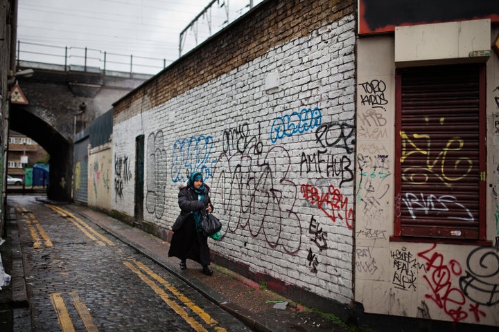 A woman walks in an alley in Bethnal Green, a Muslim-dominated neighborhood in East London. Cameron told BBC R