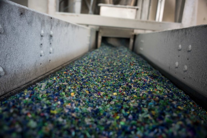 A picture taken on November 3, 2015 shows shredded plastic waste collected in the sea by fishermen on a conveyer belt at a plastic processing plant in Chiva, near Valencia, Spain.