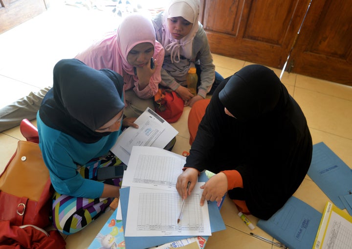 Female motorbike taxi drivers are seen registering themselves as they join the online order transport company.