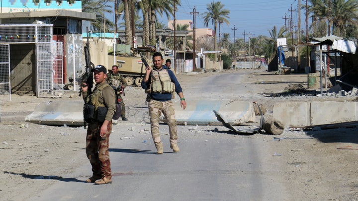 Iraqi security forces secure a street in Ramadi, Iraq. The U.N. report said the majority of those being held are women and children from the Yezidi community.