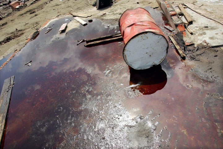 A barrel lies in a pool of oil at a damaged petroleum plant on Jan. 15, 2005, in Indonesia, after a 9.0 earthquake and subsequent tsunami. Oil is incredibly cheap these days, but that doesn't spell doom for renewables.